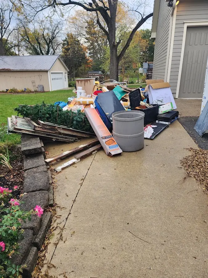 Dumpster being loaded with debris for Roofing Dumpster Rental in Badger